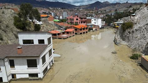 cleaning mud Bolivia|Heavy rains in Bolivia send mud crashing into the capital, leaving .